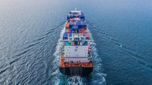 Aerial view of freighter at sea away